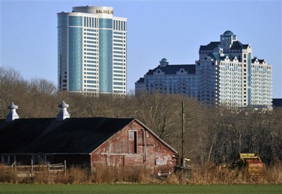Foxwoods Resorts Casino and MGM Grand at Foxwoods loom behind a barn in Mashantucket, Conn.